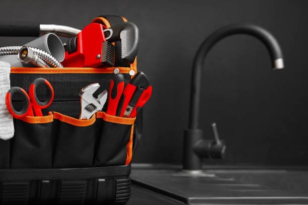 Plumber's tool bag on kitchen counter near sink, space for text